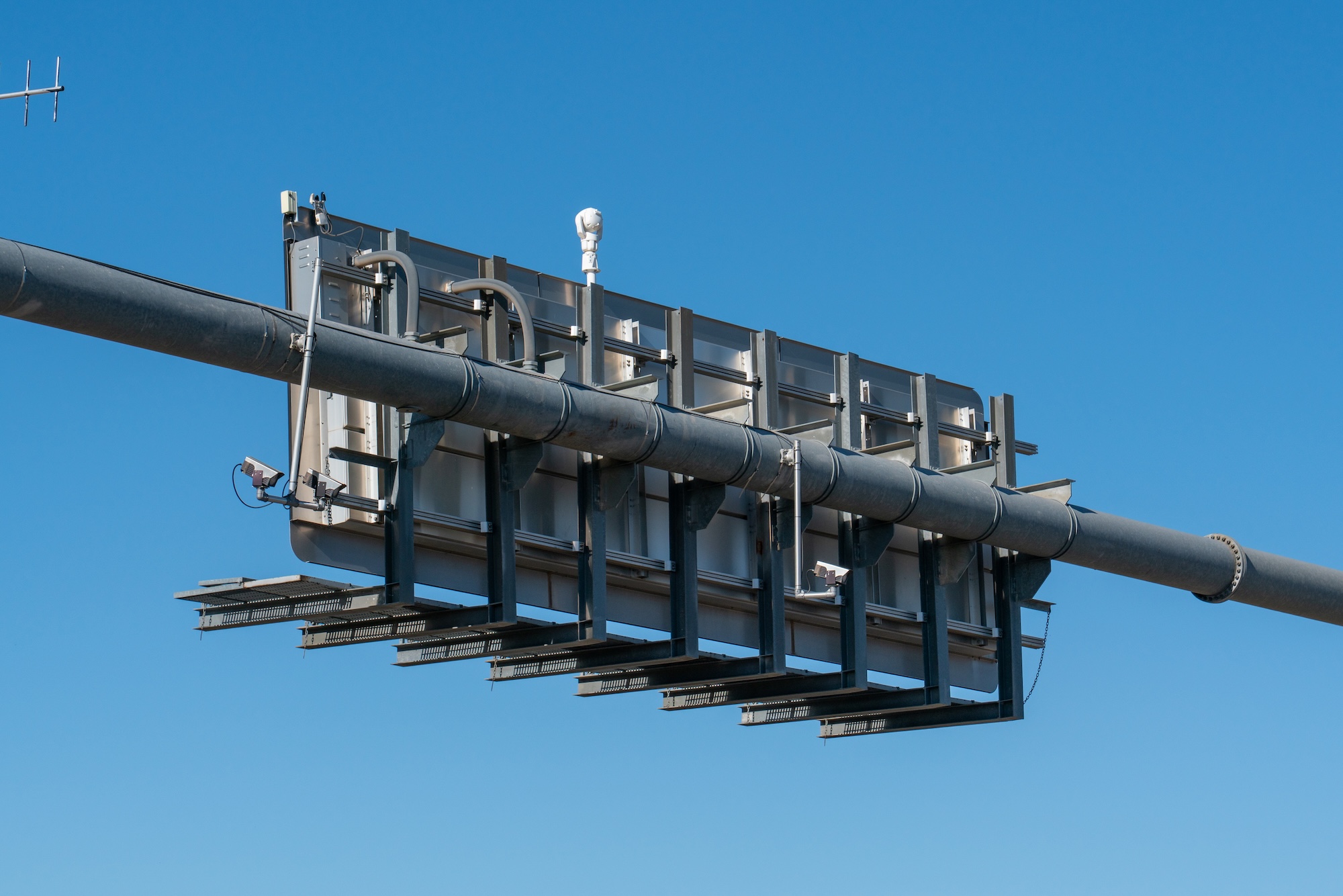 The back of a highway overpass sign with ALPR cameras.